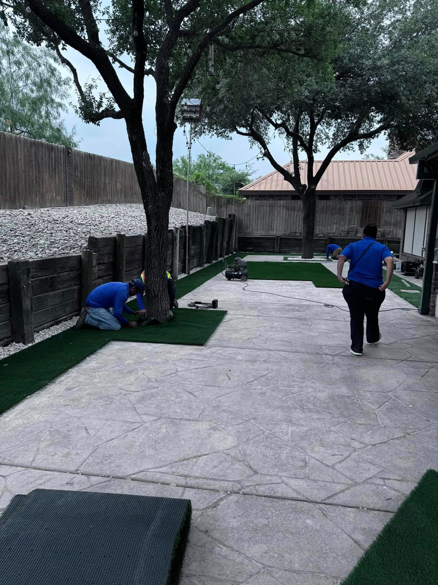 The Southern Gardens crew installing artificial turf on a South Texas property